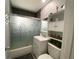 Bathroom showcasing a vanity, shower/tub combo with glass doors, and built-in shelving unit at 21298 Austin Ave, Port Charlotte, FL 33952
