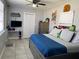 Well-lit bedroom with a modern ceiling fan, tiled floor, and neutral paint at 21298 Austin Ave, Port Charlotte, FL 33952