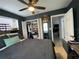Well-lit bedroom featuring a ceiling fan, closet, and doorway leading to another room at 21298 Austin Ave, Port Charlotte, FL 33952