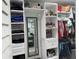 Organized walk-in closet featuring shelving and hanging storage, with a mirror for convenience at 21298 Austin Ave, Port Charlotte, FL 33952