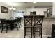 Dining area with dark wood table and chairs adjacent to the kitchen bar seating at 21298 Austin Ave, Port Charlotte, FL 33952