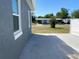 Gray house exterior featuring side yard access and view of nearby houses at 21298 Austin Ave, Port Charlotte, FL 33952