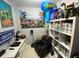 Game room features a black recliner, white shelves, and an accent wall with gaming decorations at 21298 Austin Ave, Port Charlotte, FL 33952