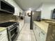 Modern kitchen with stainless steel appliances, granite countertops, and white cabinetry at 21298 Austin Ave, Port Charlotte, FL 33952