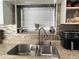 Kitchen sink with stainless steel faucet with decoratively tiled backsplash and ample lighting at 21298 Austin Ave, Port Charlotte, FL 33952