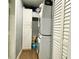 Laundry room with a stacked washer and dryer and shelving, providing ample storage space at 21298 Austin Ave, Port Charlotte, FL 33952