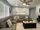 Relaxing living room featuring a gray sectional sofa, stylish pillows, and a decorative coffee table at 21298 Austin Ave, Port Charlotte, FL 33952