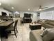 Open-concept living area with tile flooring, a comfortable gray sectional, and seamless flow to the kitchen at 21298 Austin Ave, Port Charlotte, FL 33952