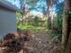 The image shows a backyard in need of maintenance and a fence in the background at 2610 E 26Th Ave, Tampa, FL 33605
