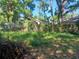 The image shows a backyard in need of maintenance and other homes in the background at 2610 E 26Th Ave, Tampa, FL 33605