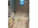 Bathroom features a standard toilet and tiled bathtub and walls at 2610 E 26Th Ave, Tampa, FL 33605