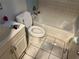 Bathroom with tiled walls, toilet, bathtub, and vanity at 2610 E 26Th Ave, Tampa, FL 33605