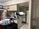 Picture of kitchen featuring dated appliances, laminate counters, tile floors, and a soda machine at 2610 E 26Th Ave, Tampa, FL 33605