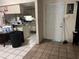 Living and dining area featuring tile floor, white walls, and views to the kitchen at 2610 E 26Th Ave, Tampa, FL 33605