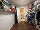 Spacious walk-in closet with shelving and rods, leading to the bathroom for added convenience at 2625 State Road 590 # 2613, Clearwater, FL 33759