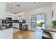 Bright kitchen with white cabinets, granite countertops, stainless steel appliances and sliding doors to the outside patio at 2721 W Gray St, Tampa, FL 33609