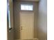 Inviting foyer featuring a transom window letting in natural light and neutral wall colors at 30049 Emmetts Ct, Wesley Chapel, FL 33543