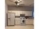 Functional kitchen featuring white appliances, ample cabinetry, and a ceiling fan at 30049 Emmetts Ct, Wesley Chapel, FL 33543