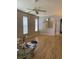 Open living room with hardwood floors, fan and light fixture at 30049 Emmetts Ct, Wesley Chapel, FL 33543