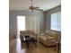 Bright living room featuring hardwood floors, neutral wall colors, a ceiling fan and lots of natural light at 30049 Emmetts Ct, Wesley Chapel, FL 33543