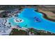 Aerial view of a large community pool area featuring beach access, and an aqua park at 31452 Cabana Rye Ave, San Antonio, FL 33576