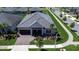 An aerial view showcases the home's tile roof, landscaping, and location in a residential neighborhood at 31452 Cabana Rye Ave, San Antonio, FL 33576