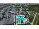 Aerial view of the community with swimming pool, tennis courts, bocce ball and a parking lot at 31452 Cabana Rye Ave, San Antonio, FL 33576