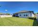 Beautifully maintained backyard with lush lawn and partial view of the home's exterior at 31452 Cabana Rye Ave, San Antonio, FL 33576