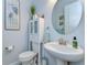 Charming powder room features a pedestal sink, stylish mirror, and decorative touches at 31452 Cabana Rye Ave, San Antonio, FL 33576