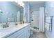 Bright bathroom with double vanity, white cabinets, and tub-shower combo with decorative tiling at 31452 Cabana Rye Ave, San Antonio, FL 33576