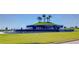 Expansive green space featuring an elevated landscaped fountain with tiered water features and palm trees at 31452 Cabana Rye Ave, San Antonio, FL 33576