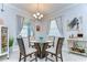Cozy dining room features a glass-topped table, comfortable seating, and elegant chandelier at 31452 Cabana Rye Ave, San Antonio, FL 33576