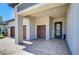 Exterior front entrance of house with brick driveway and pathway, and front door with glass at 31452 Cabana Rye Ave, San Antonio, FL 33576