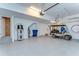 Spacious three-car garage with epoxy floor, water heater, and golf cart at 31452 Cabana Rye Ave, San Antonio, FL 33576