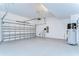 Three-car garage features epoxy floor, water heater, and ample storage space at 31452 Cabana Rye Ave, San Antonio, FL 33576
