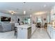 Open-concept kitchen features a large island, stainless steel appliances, and seamless flow to the living area at 31452 Cabana Rye Ave, San Antonio, FL 33576