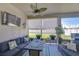 Comfortable screened-in lanai with outdoor seating, television, and a view of the backyard at 31452 Cabana Rye Ave, San Antonio, FL 33576