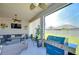 Screened in lanai featuring ample seating, ceiling fans, and a grill overlooking a manicured lawn at 31452 Cabana Rye Ave, San Antonio, FL 33576
