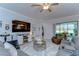 Bright living room boasts a comfortable sectional sofa, sliding glass doors for outdoor access, and inviting decor at 31452 Cabana Rye Ave, San Antonio, FL 33576