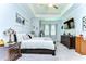 Serene main bedroom featuring tray ceilings, stylish decor, and comfortable furnishings for a relaxing retreat at 31452 Cabana Rye Ave, San Antonio, FL 33576