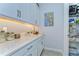 Walk-in pantry featuring granite counter, neutral backsplash, under cabinet lighting and open storage at 31452 Cabana Rye Ave, San Antonio, FL 33576
