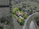 Bird's-eye view of the property displaying the landscaped yard, pool, and well-maintained exterior at 34201 Kentucky Derby Pl, Dade City, FL 33525
