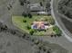 Aerial view of the property showcasing the landscaped yard, pool, and surrounding area at 34201 Kentucky Derby Pl, Dade City, FL 33525