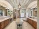 Spacious bathroom featuring a walk-in shower, soaking tub, dual vanity, and marble counter tops at 34201 Kentucky Derby Pl, Dade City, FL 33525