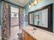 Bathroom with floral curtains, a vanity sink, and a shower area at 34201 Kentucky Derby Pl, Dade City, FL 33525