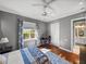 Comfortable bedroom with hardwood floors, a window view, and an open entry at 34201 Kentucky Derby Pl, Dade City, FL 33525