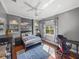 Bright bedroom with hardwood floors, built-in shelves, and a ceiling fan at 34201 Kentucky Derby Pl, Dade City, FL 33525