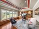 Den with hardwood floors, built-in shelves, and windows with backyard views at 34201 Kentucky Derby Pl, Dade City, FL 33525