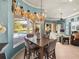 View of the dining room with chandelier and view of pool area and fireplace at 34201 Kentucky Derby Pl, Dade City, FL 33525