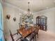 Classic dining room with dark wood table and accents and views into living room at 34201 Kentucky Derby Pl, Dade City, FL 33525